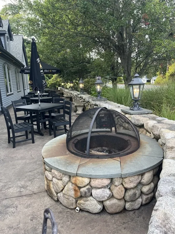 Outdoor terrace with fire pit at Amari Bar and Ristorante